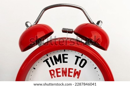 Red alarm clock with text Time To Renew