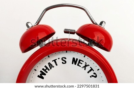 Red alarm clock with text Whats next