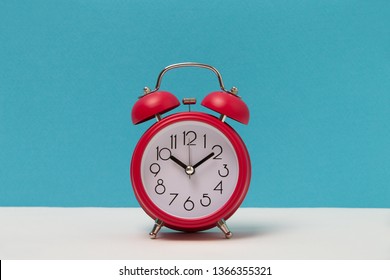 Red alarm clocks on white background and light blue background wall. front view with copy space.
