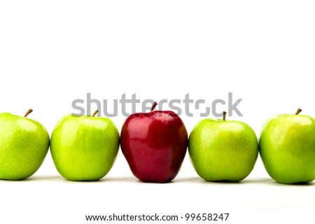 Red apple among green apples isolated on a white