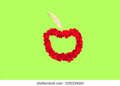 Red Apple From Red Chopped Paper And Feather On Green Background, Creative Art Design