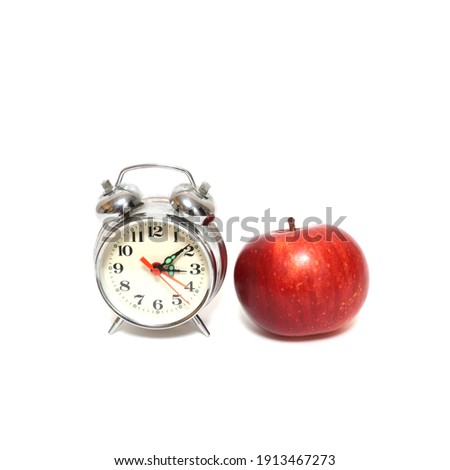 Red apple and clock isolated on white background, time concept