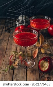 Red Apple Cocktail With Shimmer For Halloween Party On Wooden Rustic Backgroud. Selective Focus