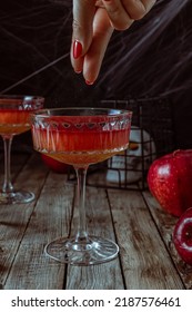 Red Apple Cocktail With Shimmer For Halloween Party On Wooden Rustic Backgroud. Selective Focus