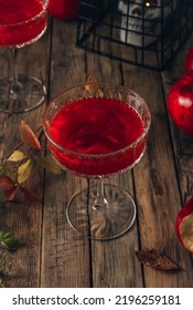 Red Apple Cocktail With Shimmer For Halloween Party On Wooden Rustic Backgroud