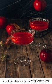 Red Apple Cocktail With Shimmer For Halloween Party On Wooden Rustic Backgroud