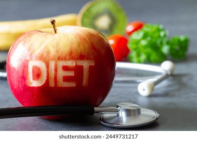 Red apple with cut-out word diet, stethoscope and fruits, diet and healthy lifestyle concept - Powered by Shutterstock