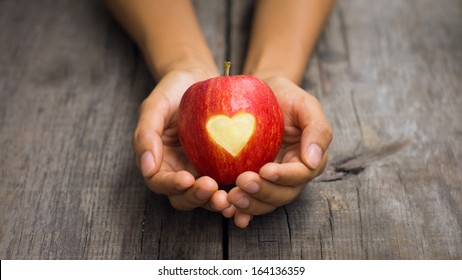 Red Apple with engraved heart - Powered by Shutterstock