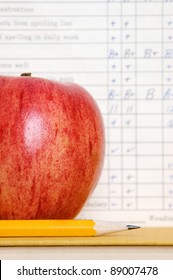 Red Apple In Front Of A Vintage Report Card