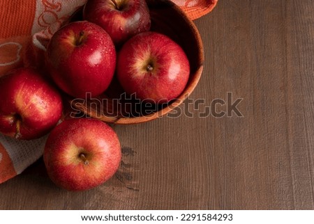 Red apple fruit isolated on wooden background.