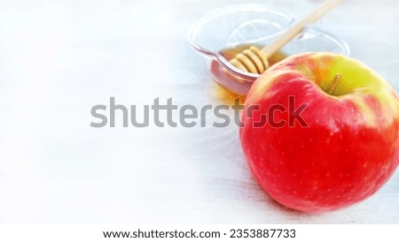 Red apple with green, Honey on a white white wooden background . A symbol of the Rosh Hashanah holiday. Suitable for shana tova greeting card. with free space for text 