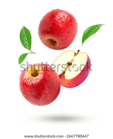 Red apple with half slice falling isolated on white background.