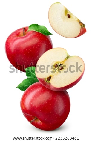 Red apple isolated. Whole, half and apple slice flying on white background. Red apples with leaves are falling. Full depth of field.