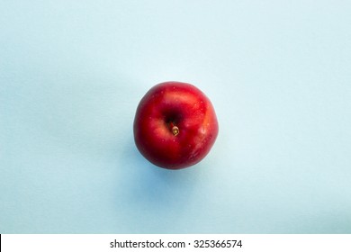 Red Apple On Blue Background, Shot From Above