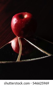 Red Apple On Cracked Broken Mirror Reflecting