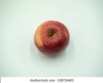 Red apple on white background, top view