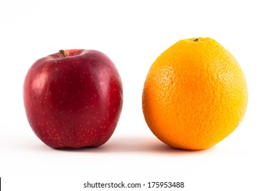 Red apple and an orange isolated on white. 