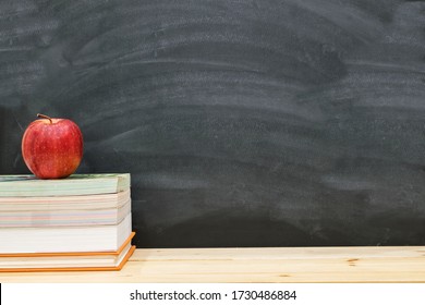 Red Apple Resting On The Book With Black Board As Background, Back To School Concept.