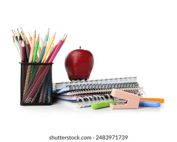 Red apple and school supplies with pencils in holder and stapler on white background - Powered by Shutterstock