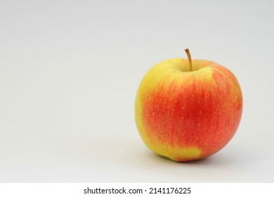 Red Apple Sitting On A Table With White Background No People Stock Photo