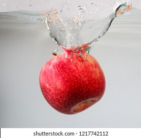 Red Apple Spash In Water On White Background