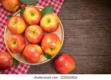 Red Apple In Wooden Plate On Wooden Background, US. Red Envy Apple On Wooden Table.