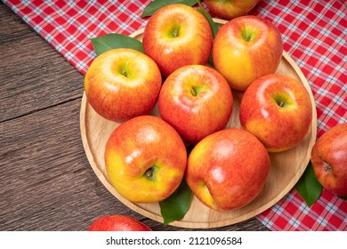 Red Apple In Wooden Plate On Wooden Background, US. Red Envy Apple On Wooden Table.