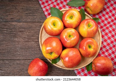 Red Apple In Wooden Plate On Wooden Background, US. Red Envy Apple On Wooden Table.