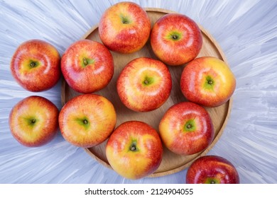 Red Apple In Wooden Plate On Wooden Background, US. Envy Apple On Wooden Table.