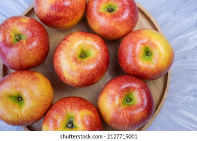 Red Apple In Wooden Plate On Wooden Background, US. Envy Apple On Wooden Table.