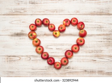 Red apples heart over rustic wooden background. Love concept - Powered by Shutterstock