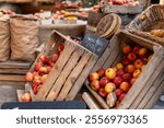 Red apples, Julia UK variety, £4.50 per kilogram, displayed in a wooden crate for sale and other fruits