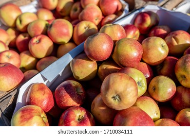 Red Apples At An Outdoor Market In A Wooden Basket