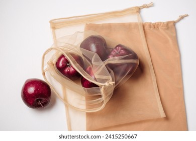 Red apples in a reusable mesh bag. Zero waste concept. - Powered by Shutterstock