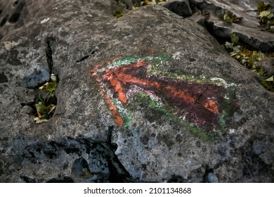 A Red Arrow Drawn On A Stone