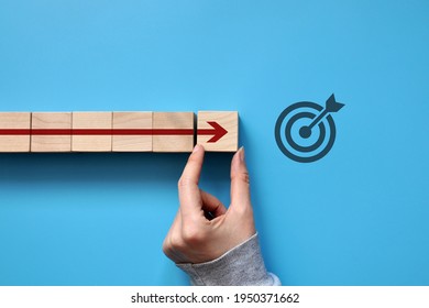 The red arrow moves towards the target. A symbol of purposeful movement towards the goal - Shutterstock ID 1950371662