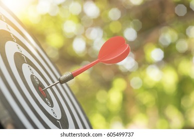 red arrow on center of dartboard. concept business goal to success. - Shutterstock ID 605499737