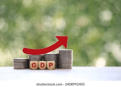 
					Red arrow on coins money and gdp word on natural green background, GDP (Gross Domestic Product) concept