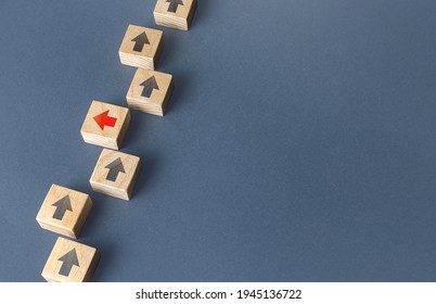 Red arrow stands out from the others and changes direction to go out of order. Thinking outside the box. New strategies and solutions. Atypical, leadership qualities. Denial of conformism. - Shutterstock ID 1945136722