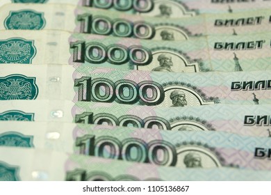 red arrows pointing down on the background of russian money