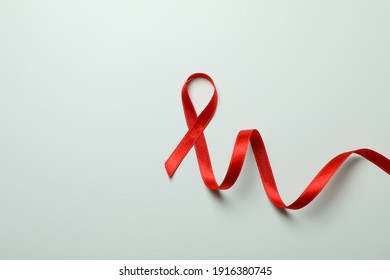 Red awareness ribbon on white background, space for text