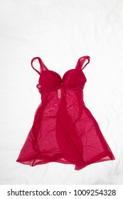 Red babydoll dress lying down on bed.