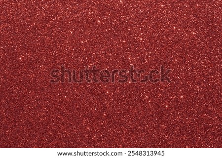 A red background with a lot of glittery red dots. The background is a deep red color, and the dots are small and shiny, giving the image a festive and celebratory feel