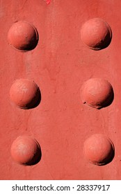 A red background with raised circles.