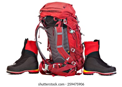 Red Backpack And Boots For Mountaineering. Studio Shoot Isolated On White Background.