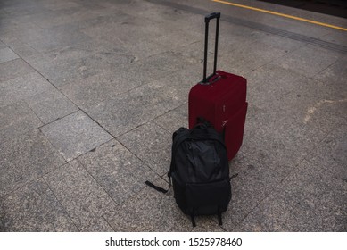 red bag and backpack on the platform