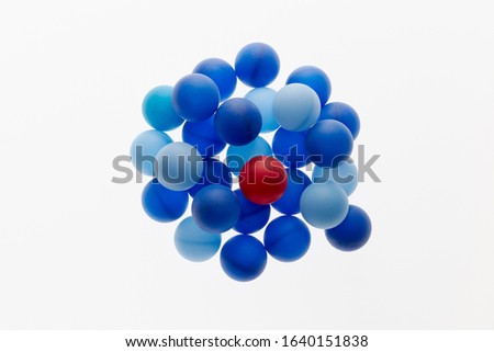 Red ball among blue spheres. Singularity concept. 