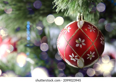 Red Ball Close-up On A Christmas Tree With A Beautiful Bokeh, Christmas Trinkets, Winter Holidays