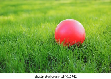 Red Ball On Green Grass.