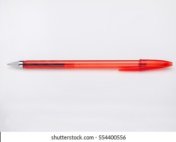 Red ballpoint gel pen on white background, uncapped